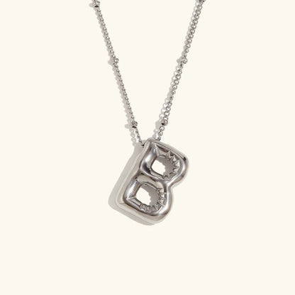 Gouden ketting met ballon-initiaal