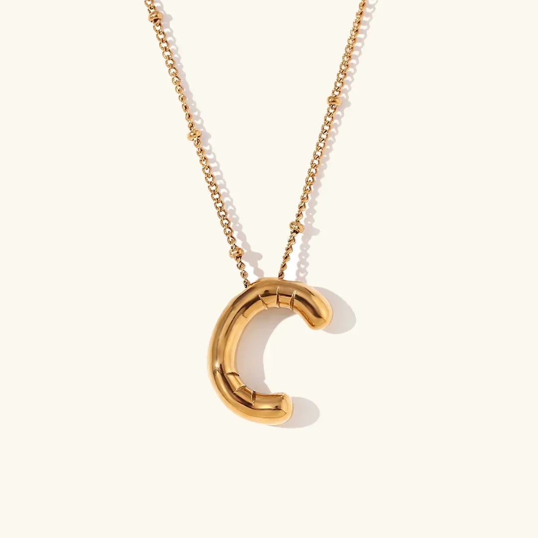 Gouden ketting met ballon-initiaal