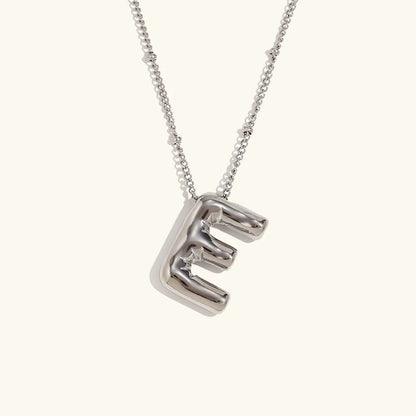 Gouden ketting met ballon-initiaal