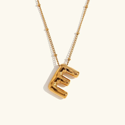 Gouden ketting met ballon-initiaal