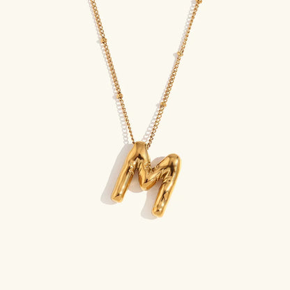 Gouden ketting met ballon-initiaal