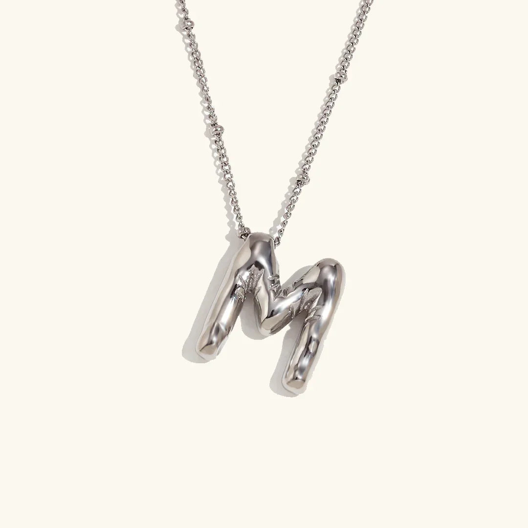 Gouden ketting met ballon-initiaal