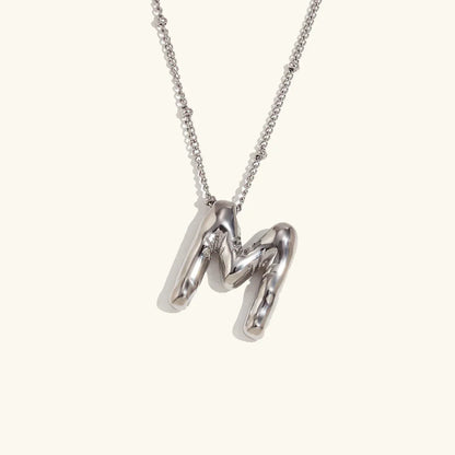 Gouden ketting met ballon-initiaal