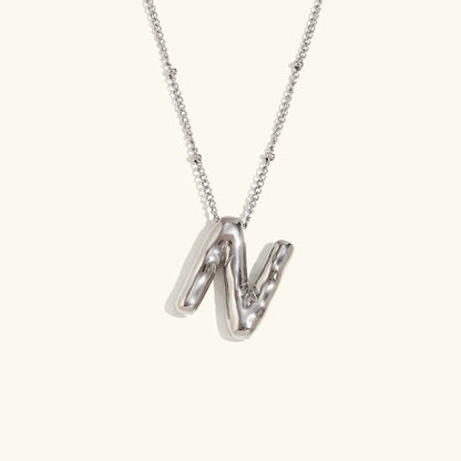 Gouden ketting met ballon-initiaal
