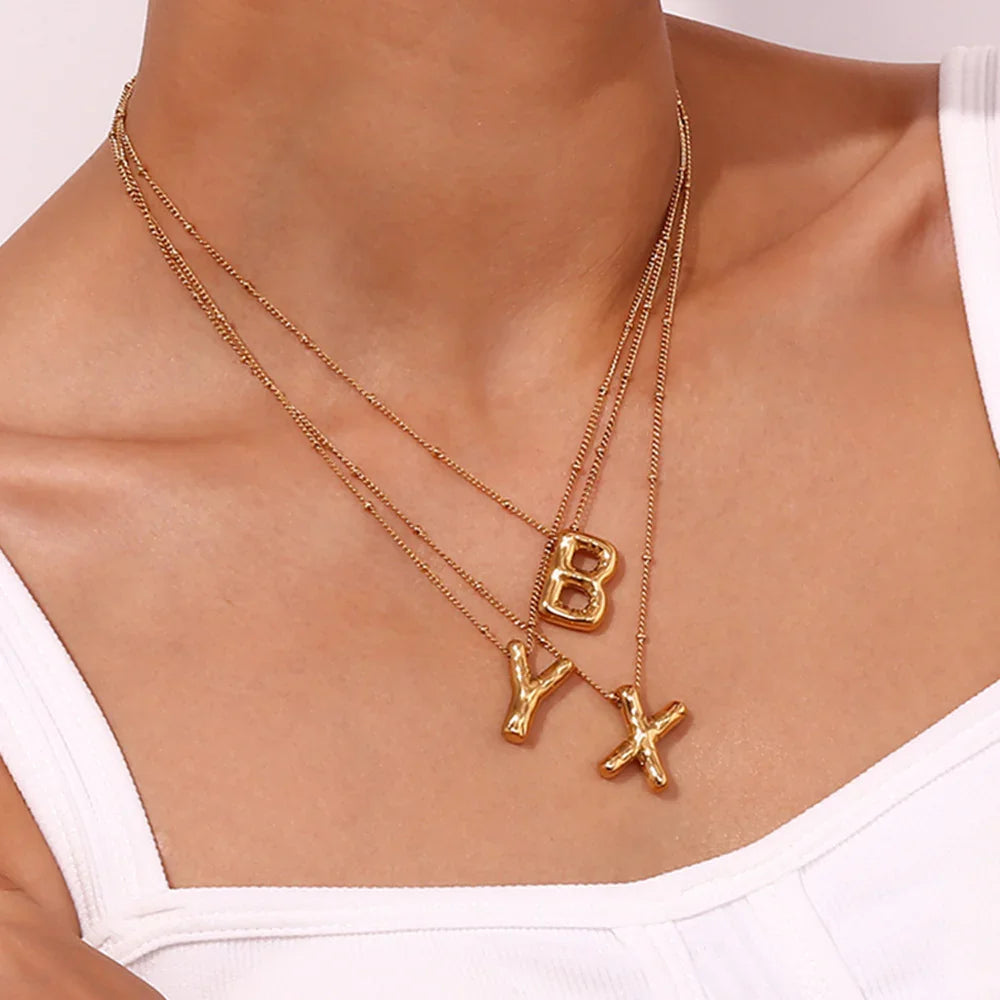 Gouden ketting met ballon-initiaal
