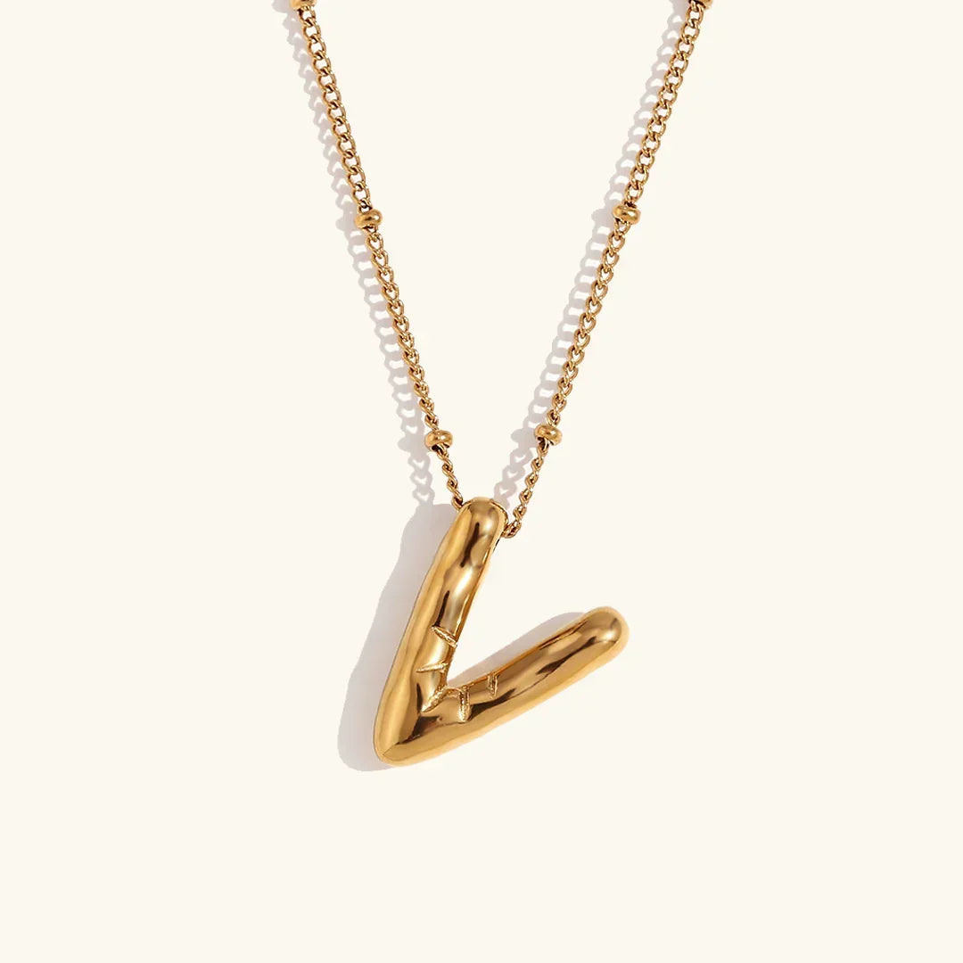 Gouden ketting met ballon-initiaal