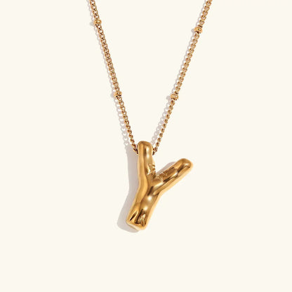 Gouden ketting met ballon-initiaal